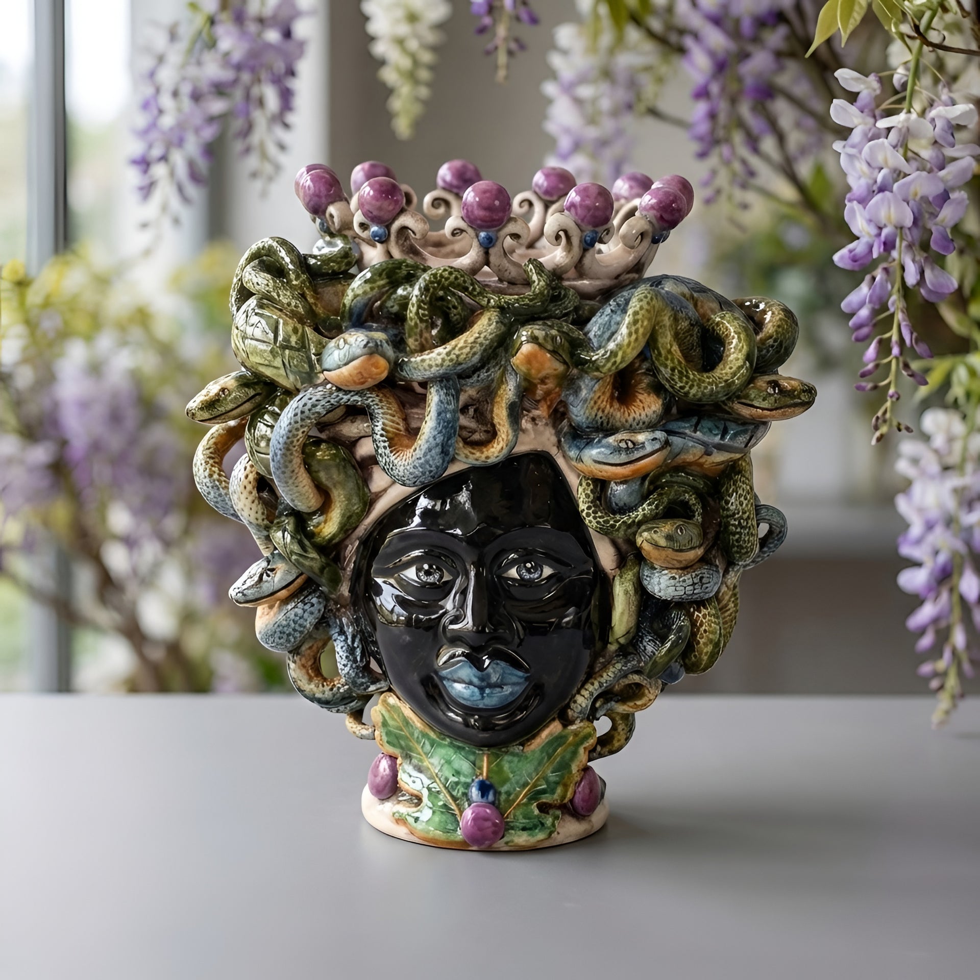 Handmade Teste di Moro ceramic vase with snake hair, purple accents, and leaf base, perfect for modern or traditional decor.