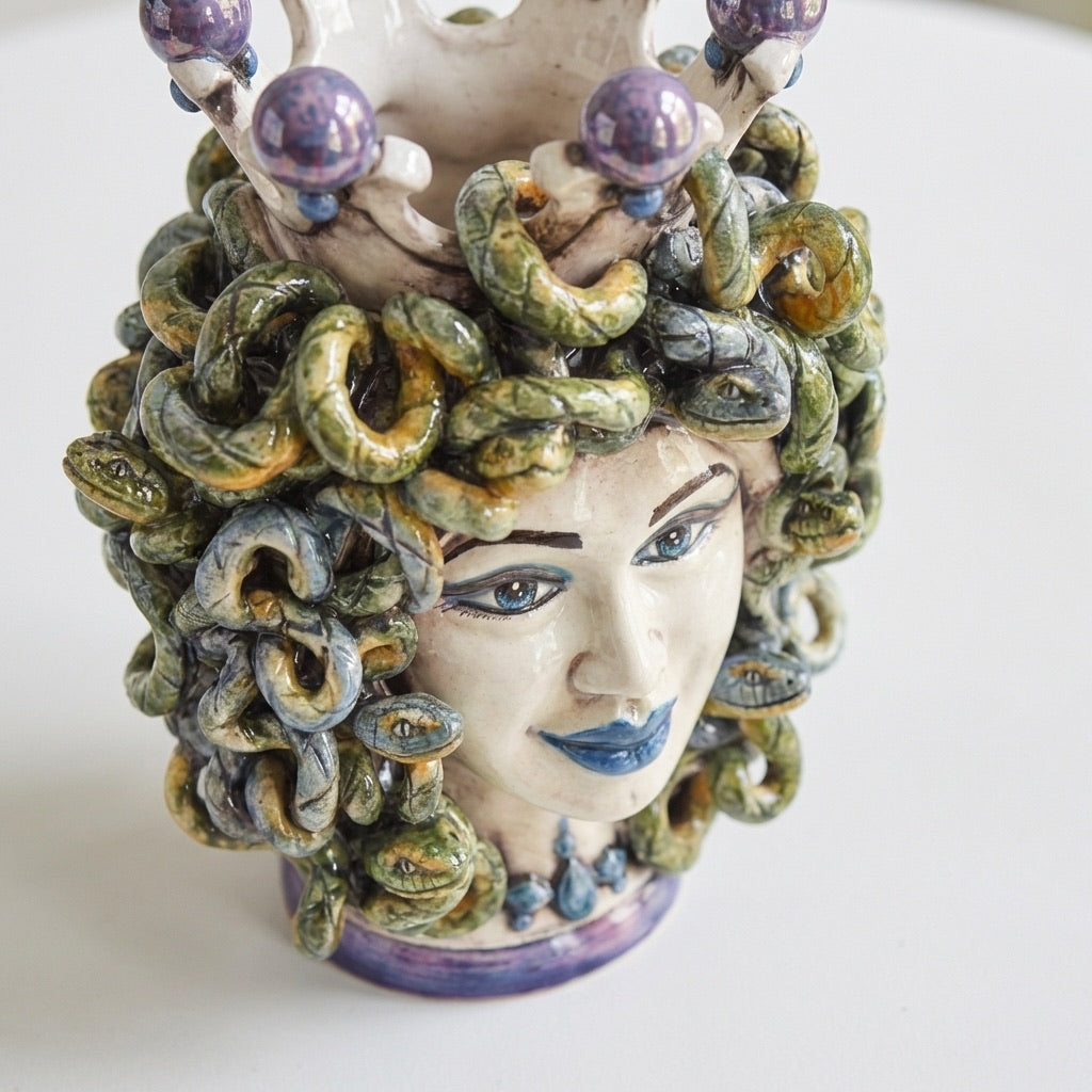 Handcrafted Medusa ceramic vase with snake hair and vibrant glaze, blending tradition and modern design.