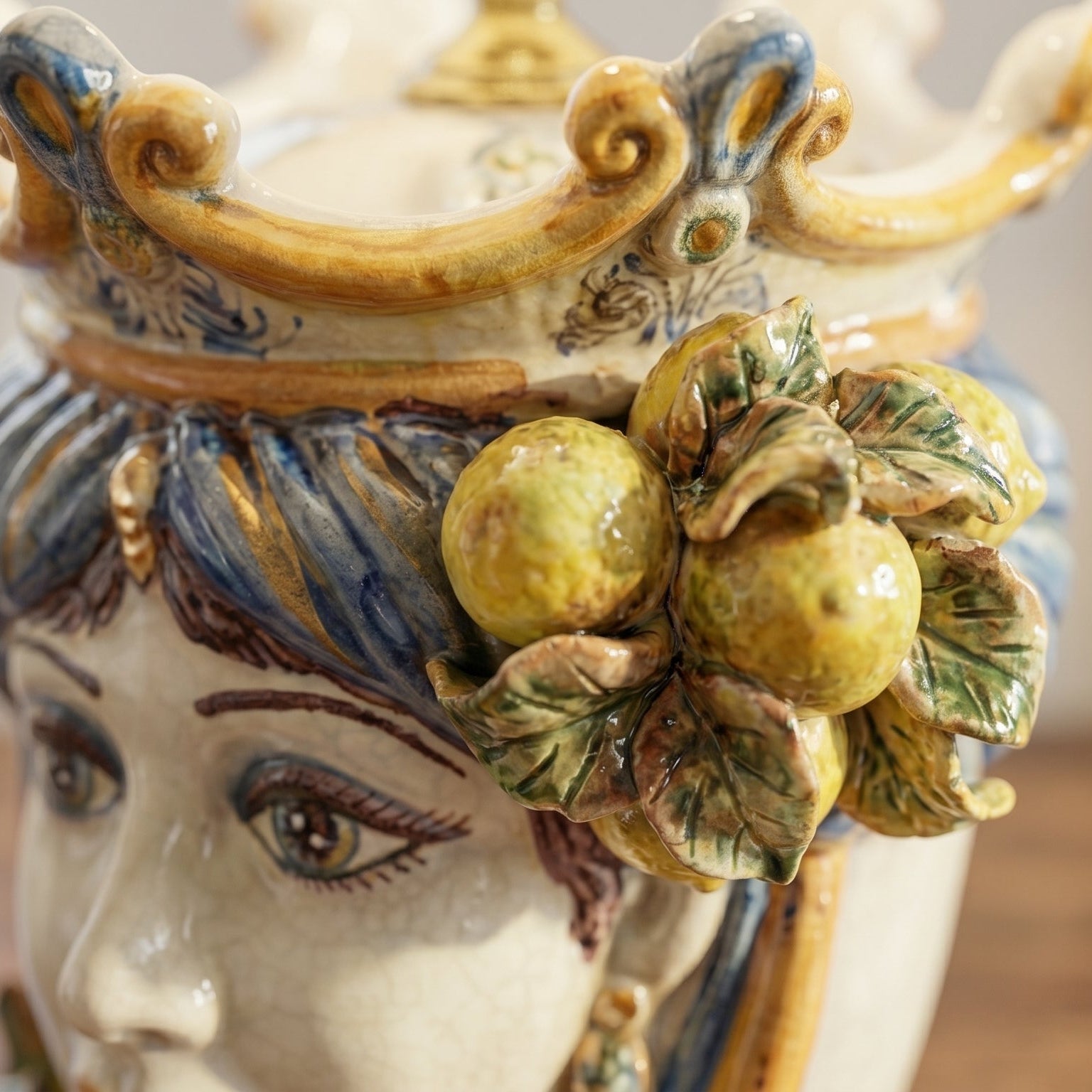 Handcrafted Teste di Moro ceramic vase with detailed face, citrus fruit, and leaf accents, blending tradition and modern design.