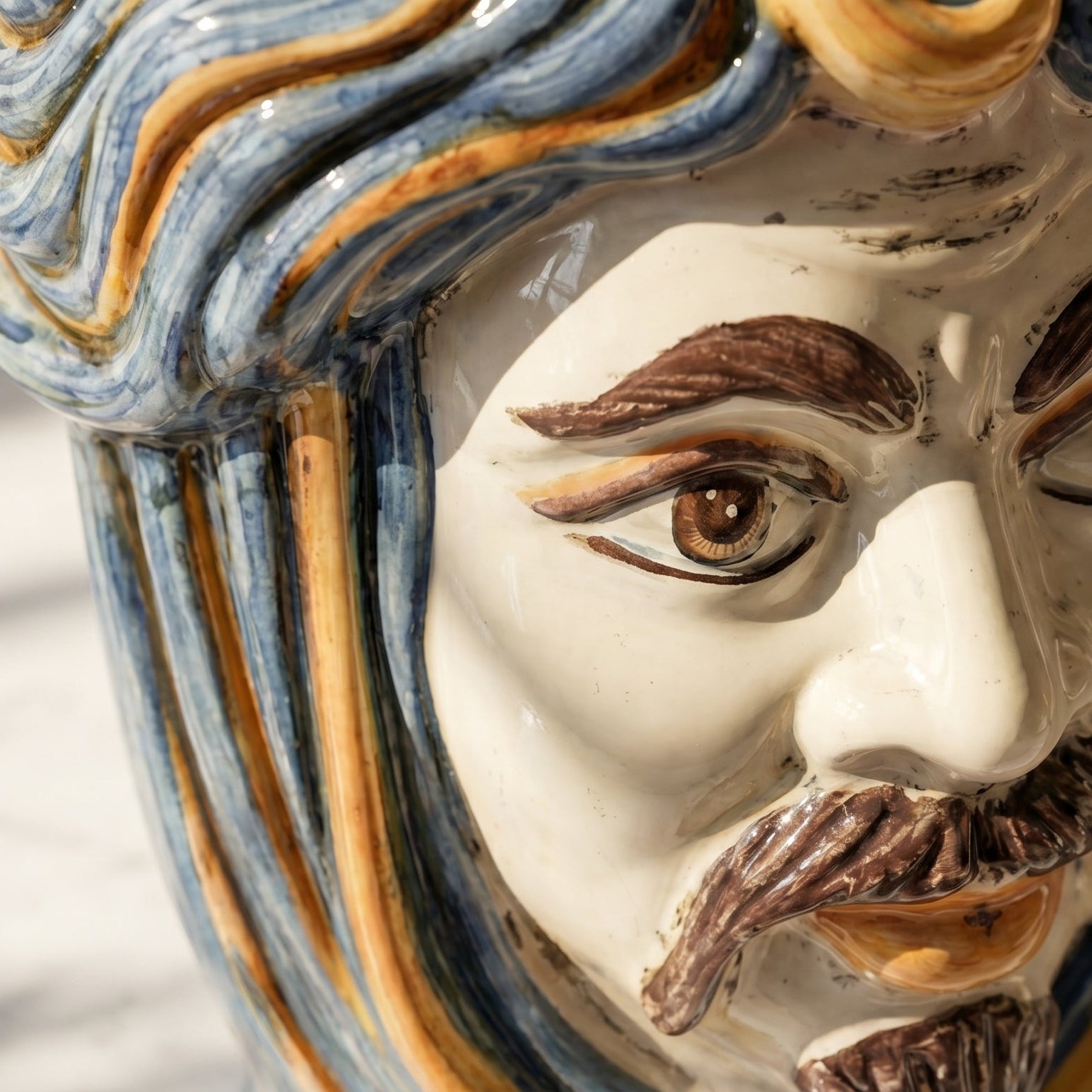 Handcrafted Teste di Moro ceramic face with blue and gold glazed hair, detailed eye and mustache