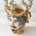 Handmade Teste di Moro ceramic vase with blue hair, mustache, and candle holders, blending tradition and modern design.