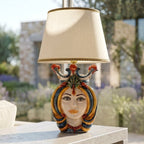 Handcrafted Teste di Moro table lamp with colorful ceramic face, crown, and beige shade, perfect for modern or traditional decor.