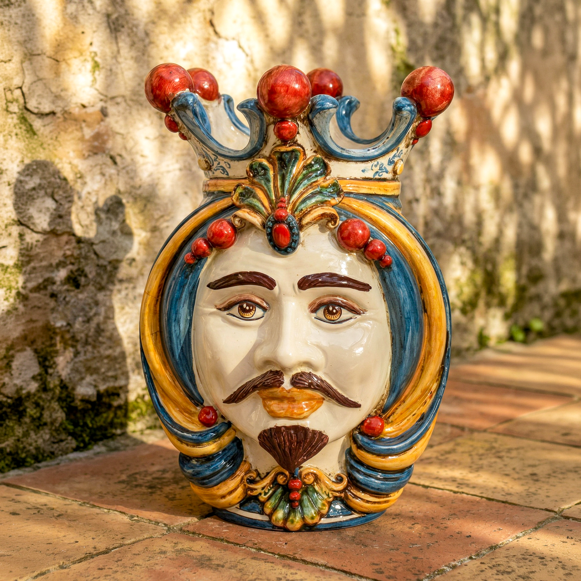 Handcrafted Teste di Moro ceramic face with crown, vibrant colors, outdoor garden decor