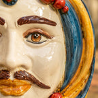 Handcrafted Teste di Moro ceramic face with detailed eye, mustache, and vibrant blue and gold accents