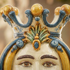 Handcrafted Teste di Moro ceramic with ornate crown, vibrant blue and gold glaze, traditional Sicilian design