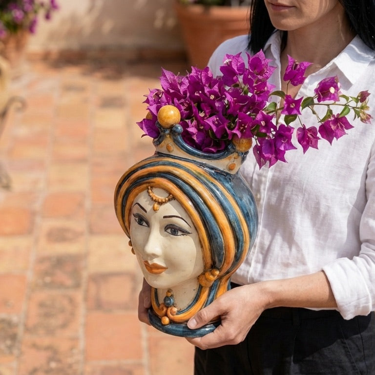 Hand-painted Teste di Moro vase with vibrant purple flowers, showcasing traditional Sicilian ceramic artistry.