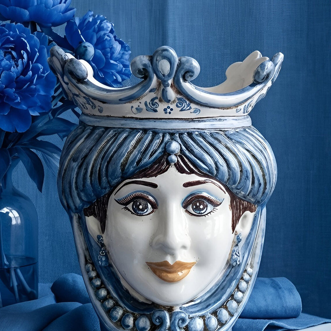 Handcrafted Teste di Moro ceramic vase with blue crown, floral accents, and elegant facial details
