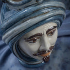 Handcrafted Teste di Moro ceramic vase with blue turban, expressive eyes, and mustache, blending tradition and modern design.