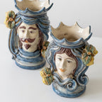 Handmade Teste di Moro ceramic vases with blue swirls, floral accents, and expressive faces, blending tradition and modern design.