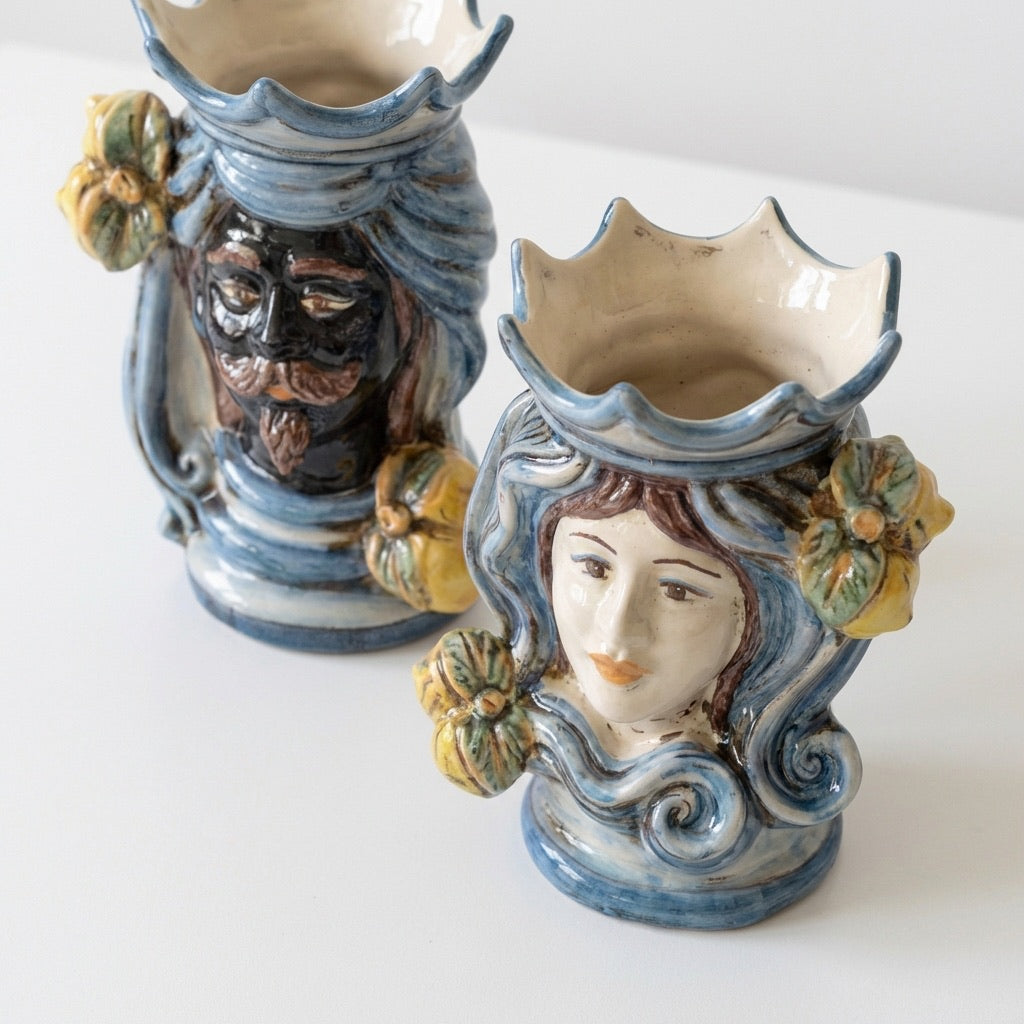 Handmade Teste di Moro ceramic vases with male and female faces, blue swirls, and floral details