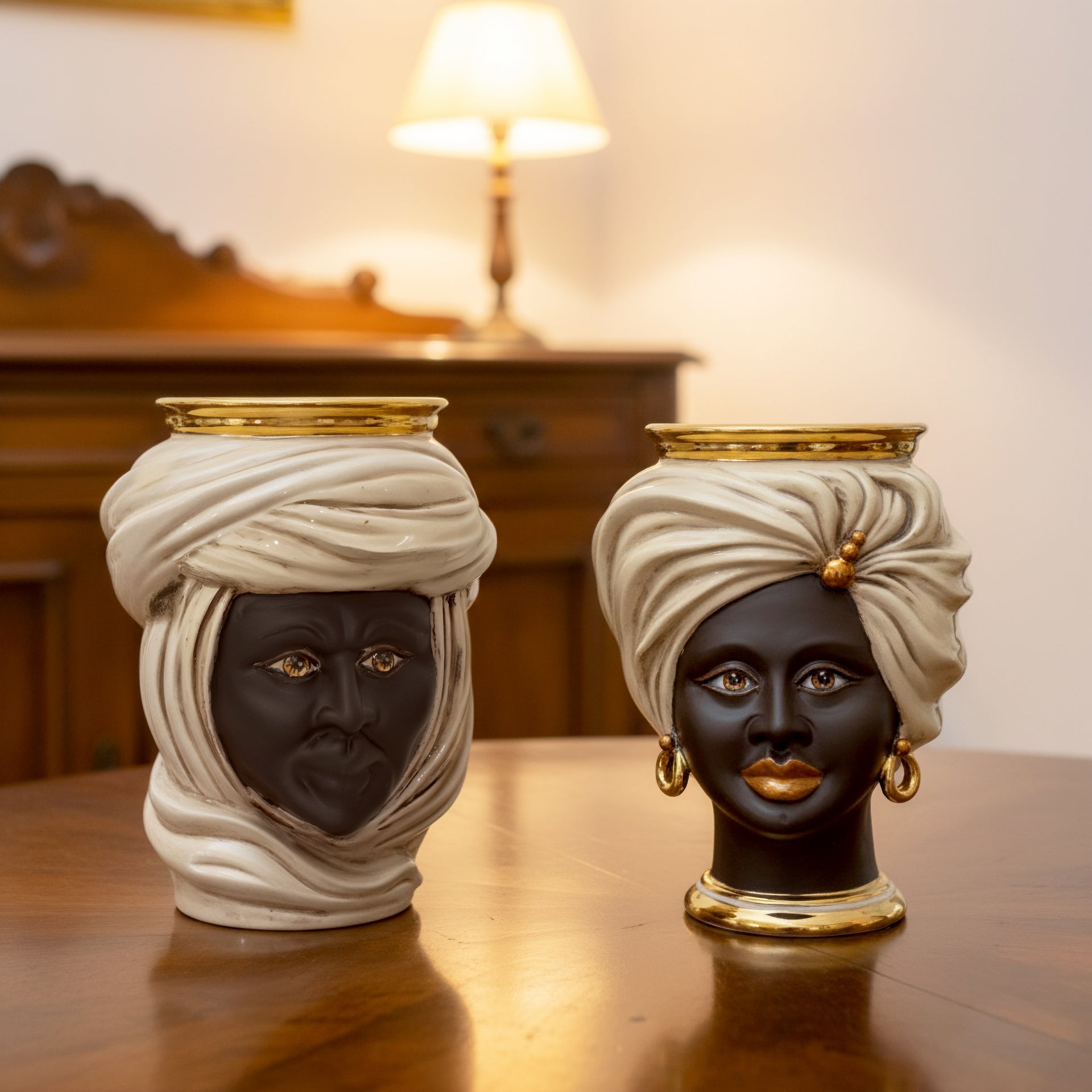 Handmade Teste di Moro ceramic vases with gold accents, featuring male and female faces in white turbans, perfect for home decor.