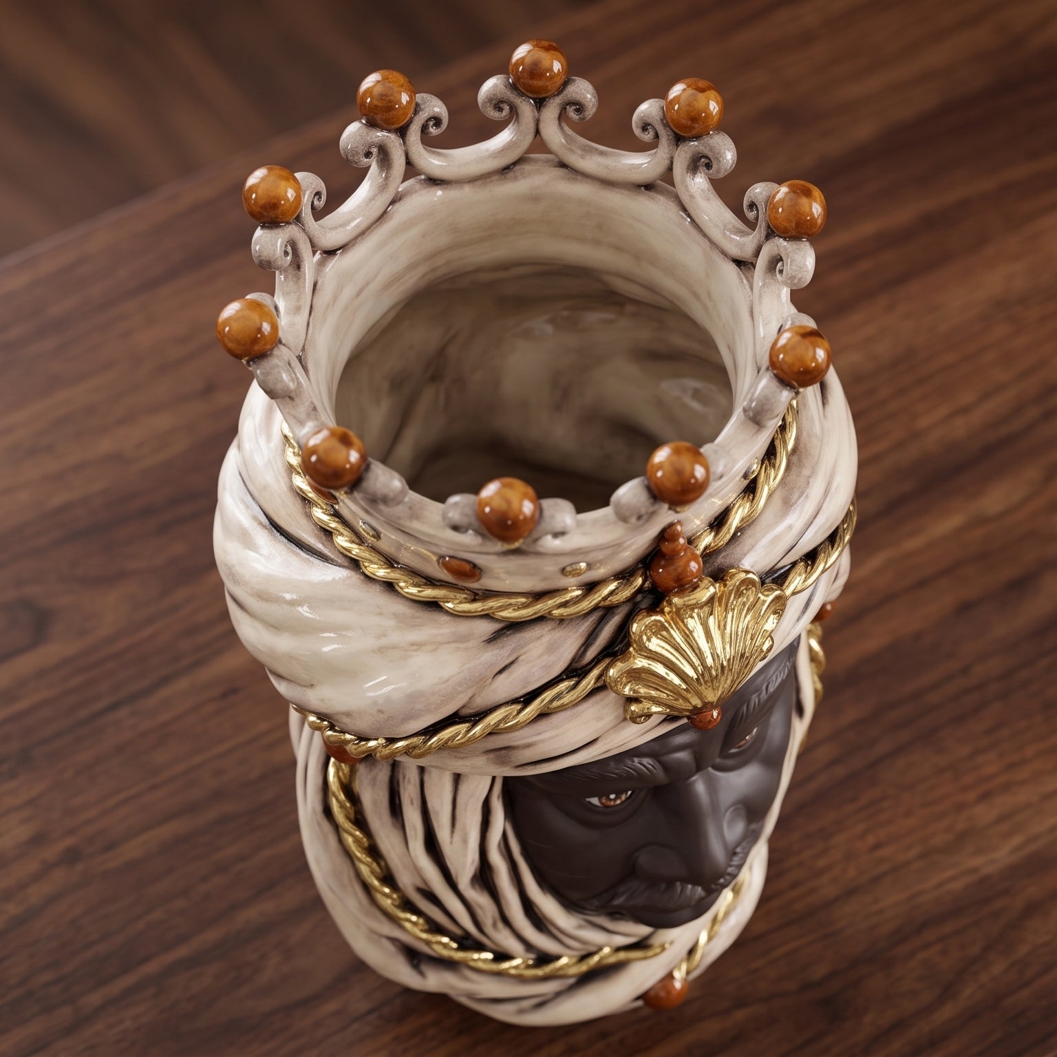 Handcrafted Teste di Moro vase with ornate crown, gold rope, and turban detail on wood surface