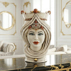 Handmade Teste di Moro ceramic vase with ornate crown, blue eyes, and red lips, displayed on marble table.