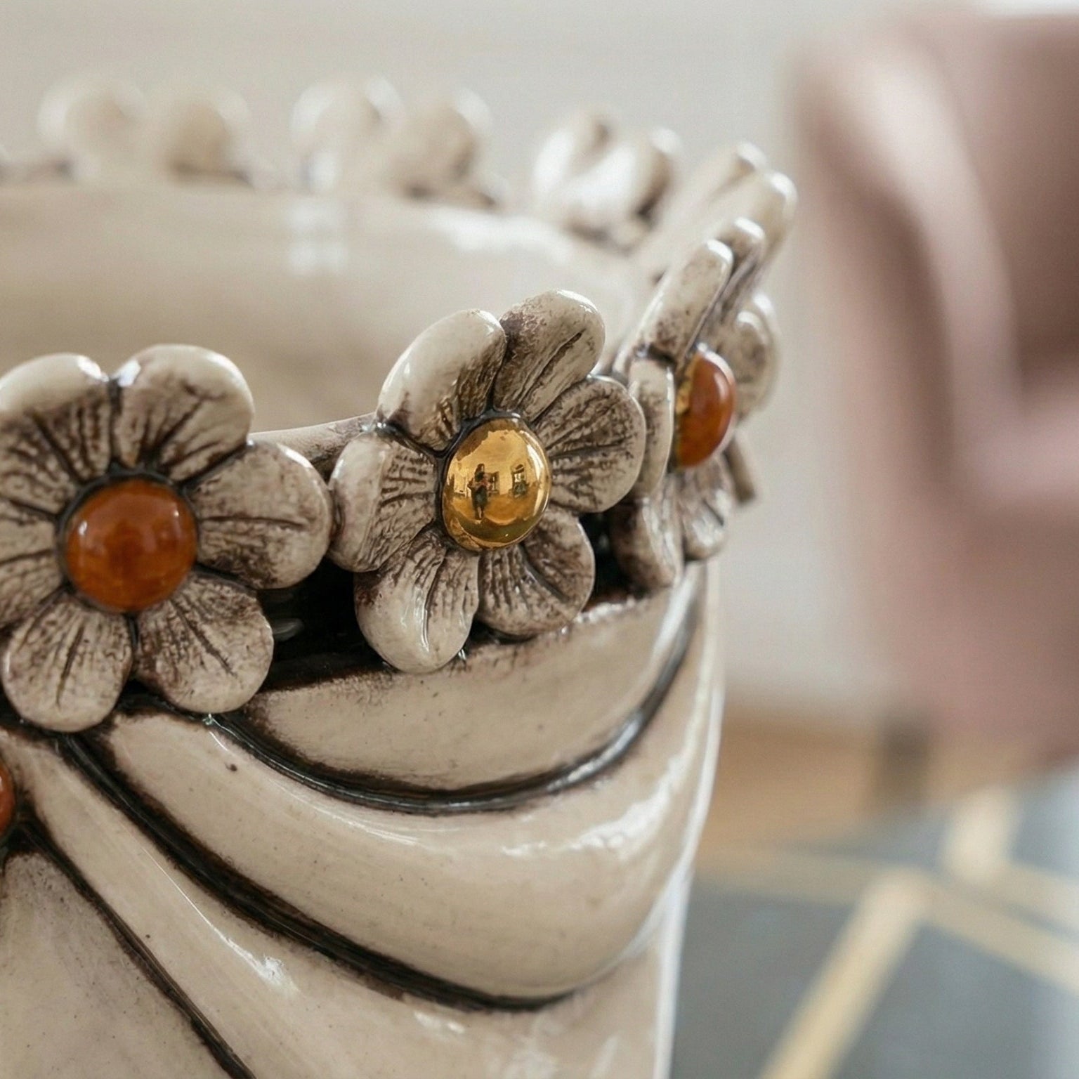 Handcrafted ceramic vase with floral details and amber accents, blending tradition and modern design.