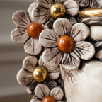 Handcrafted ceramic flower decoration with amber and gold centers, blending tradition and modern design