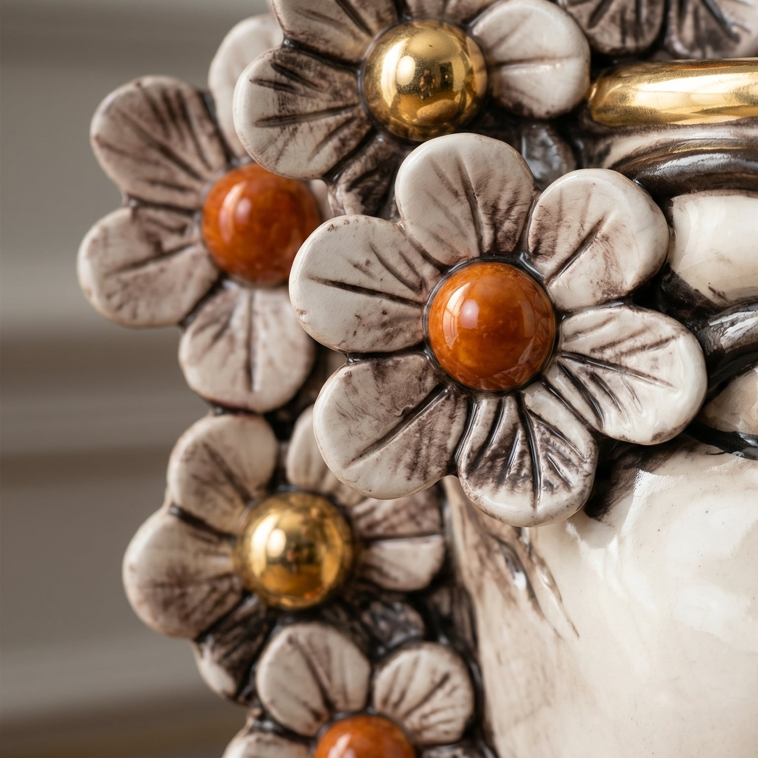 Handcrafted ceramic flower decoration with amber and gold centers, blending tradition and modern design