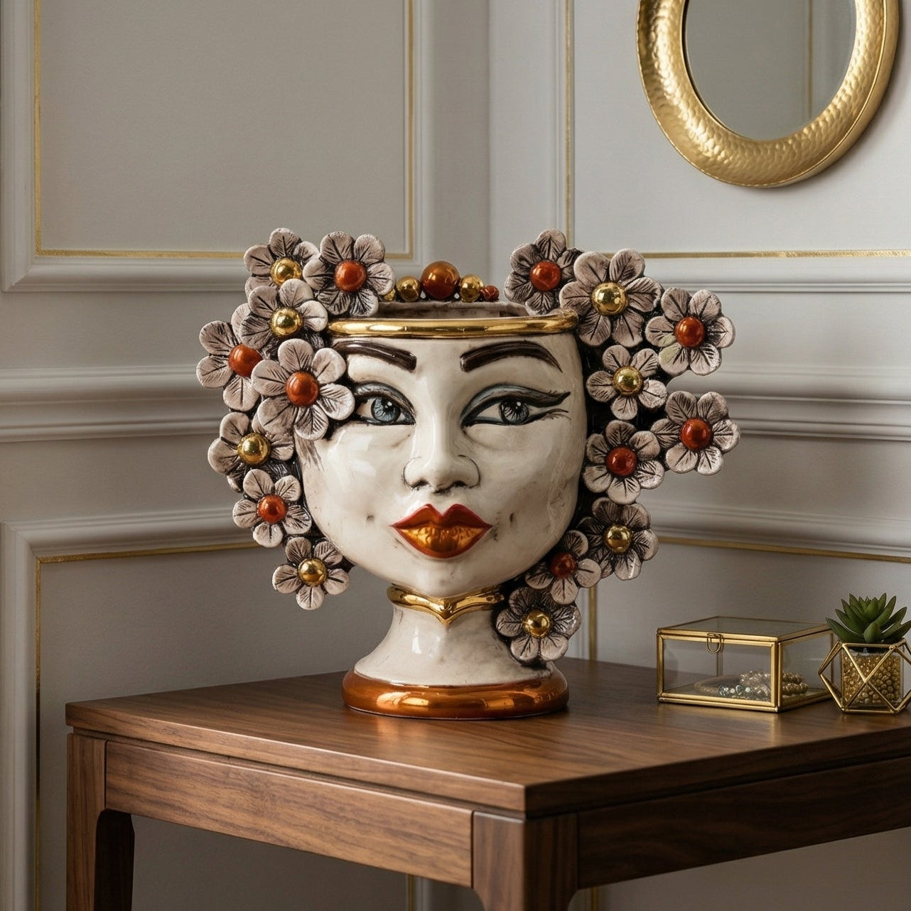 Handmade Teste di Moro vase with floral crown, gold accents, and expressive face, styled on wooden console table.