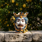 Handmade Teste di Moro ceramic vase with crown, blue hair, mustache, lemon accents, on stone wall