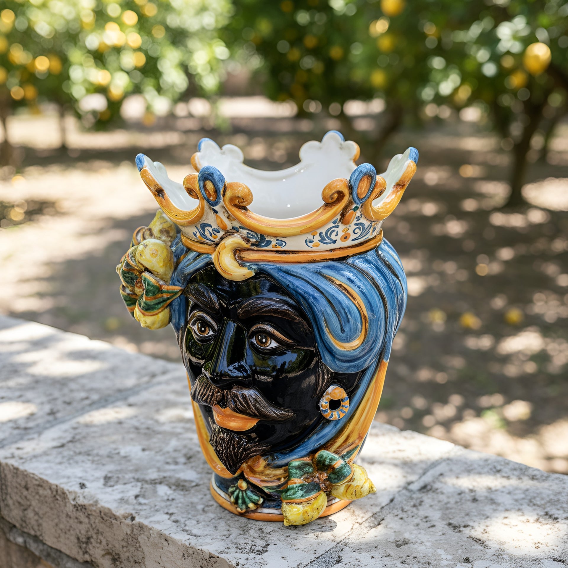 Handcrafted Teste di Moro vase with blue turban, crown, and lemon accents, showcasing Sicilian ceramic art.