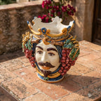Handcrafted Teste di Moro vase with crown, grapes, and mustache, perfect for rustic decor