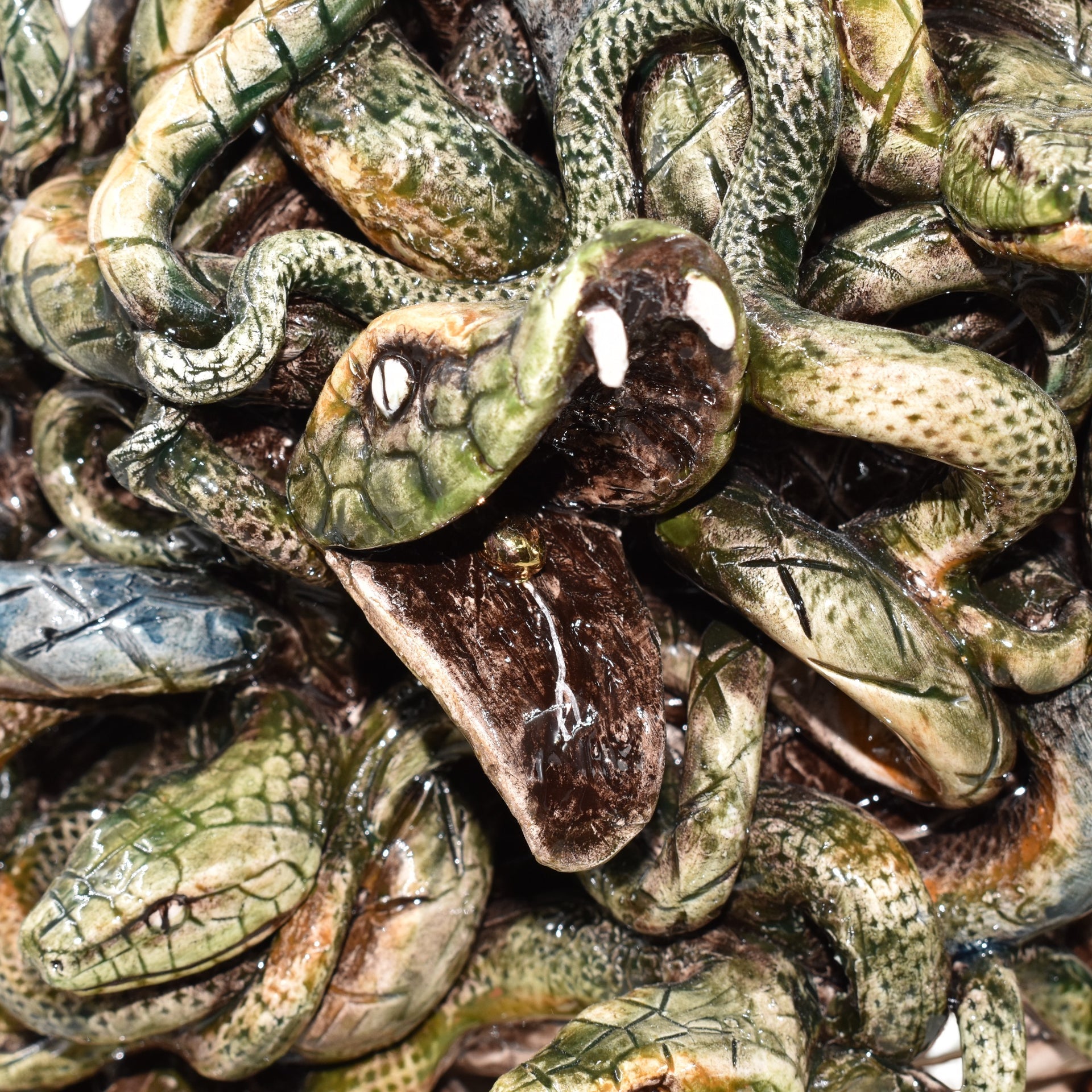 Handcrafted ceramic snake sculpture with detailed scales and open mouth, perfect for modern or traditional decor.