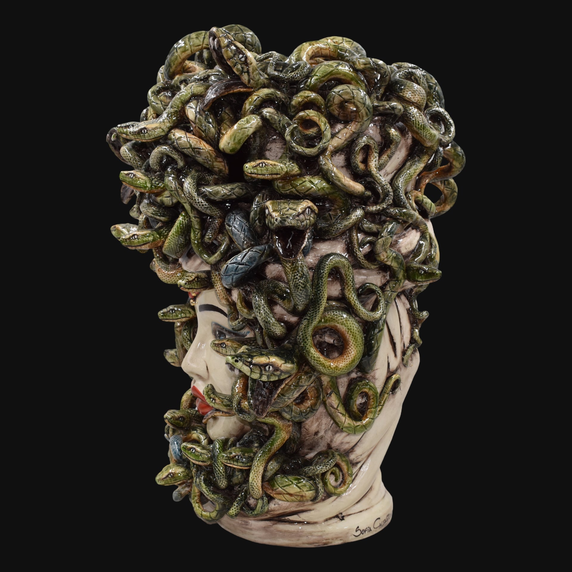 Handcrafted Medusa head sculpture with green snakes, ceramic art for modern home decor