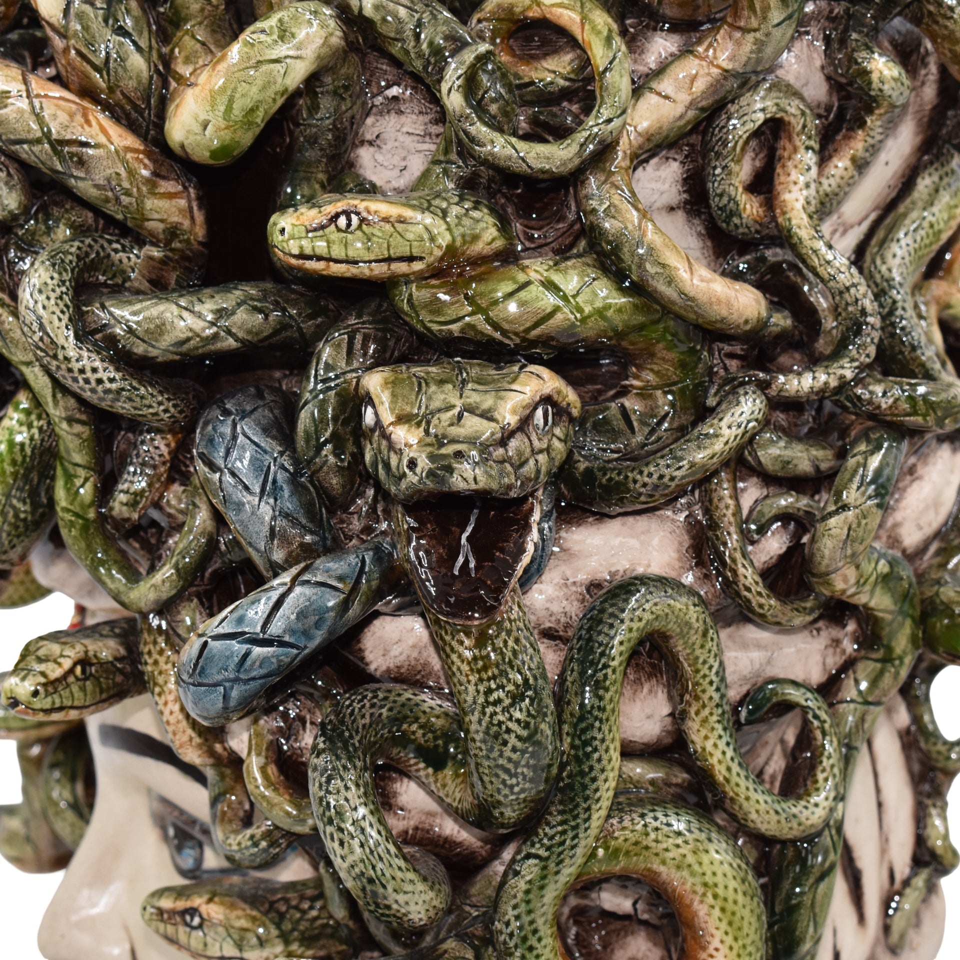 Handcrafted ceramic snake sculpture with intricate green scales, coiled design, and detailed textures for modern decor