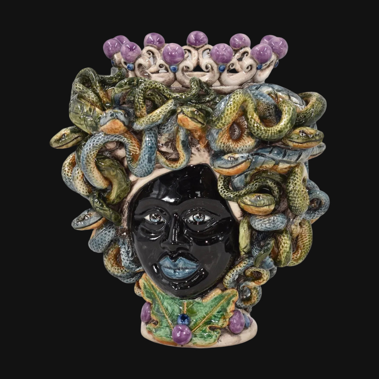 Handmade Teste di Moro ceramic vase with Medusa snake hair, purple beads, and green leaves, blending tradition and modern design.