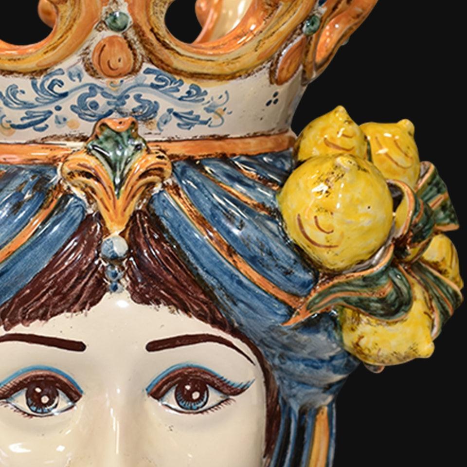 Handcrafted Teste di Moro ceramic with vibrant blue hair, lemon accents, and ornate crown details
