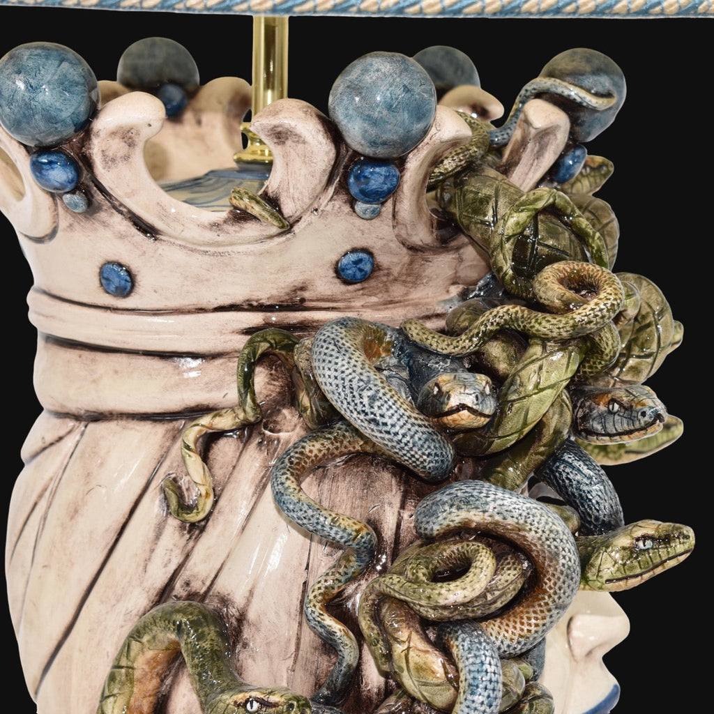 Handcrafted Teste di Moro lamp with coiled snakes and blue accents, blending tradition and modern design.