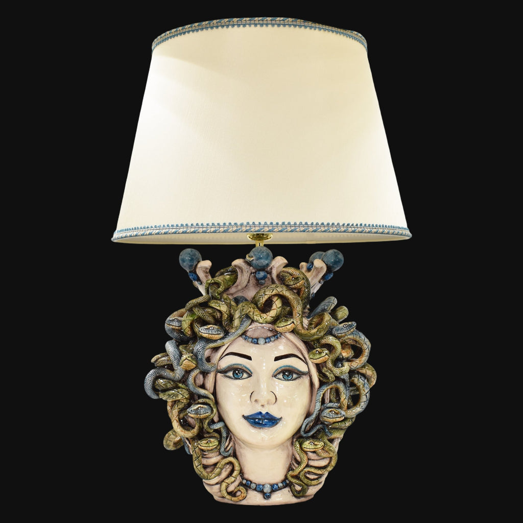 Handmade Medusa head table lamp with snake hair, blue accents, and cream shade, blending tradition and modern design.