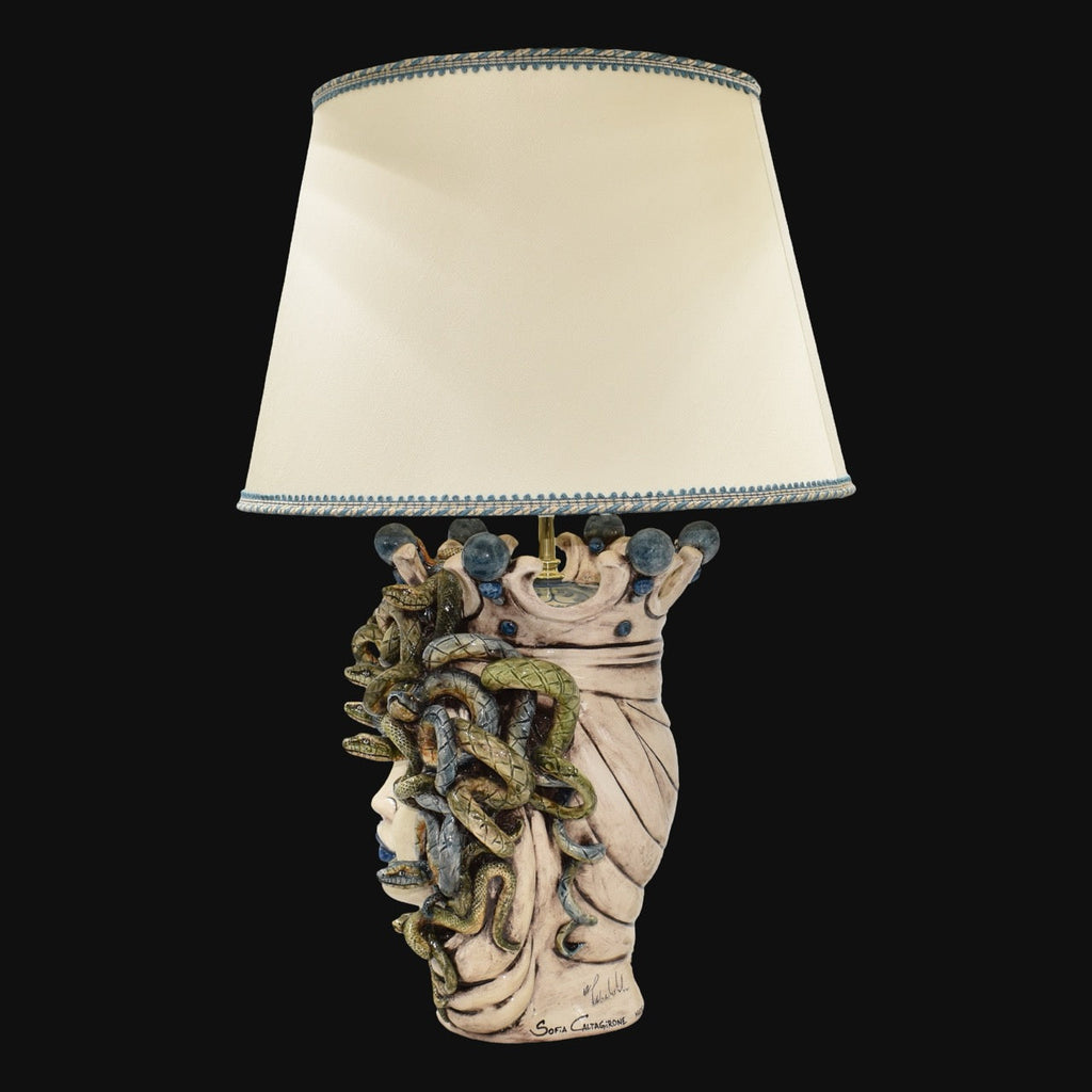 Handcrafted Medusa head table lamp with snake details and cream shade, blending tradition and modern design