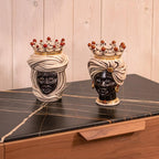 Handcrafted Teste di Moro ceramic heads with crowns, displayed on marble surface, blending tradition and modern design.
