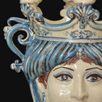 Handcrafted Teste di Moro ceramic with blue and white glaze, intricate scrollwork, and detailed facial features