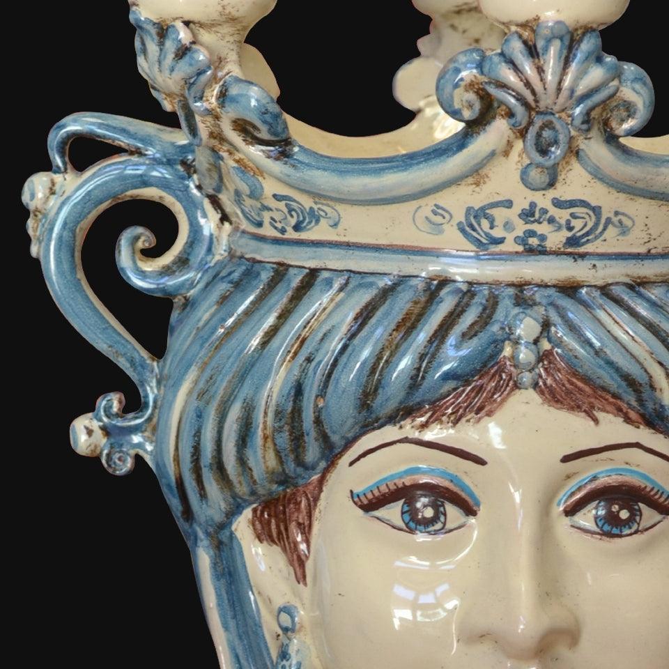 Handcrafted Teste di Moro ceramic with blue and white glaze, intricate scrollwork, and detailed facial features