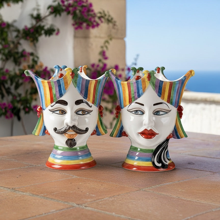 Hand-painted Teste di Moro ceramic vases with colorful stripes, male and female faces, outdoor setting
