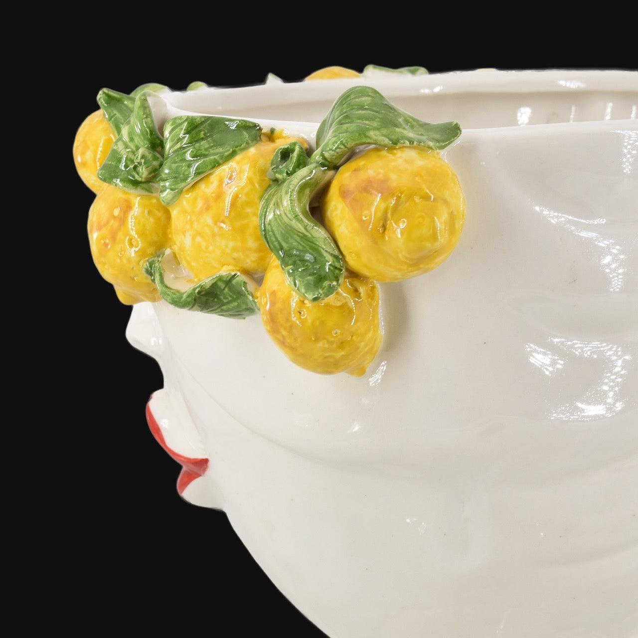 Handmade ceramic Testa di Moro with vibrant yellow lemons and green leaves, traditional Sicilian decor