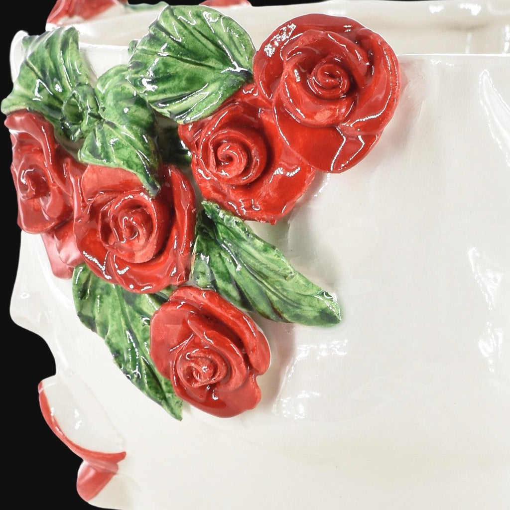 Handcrafted ceramic vase with vibrant red roses and green leaves, blending tradition and modern design.