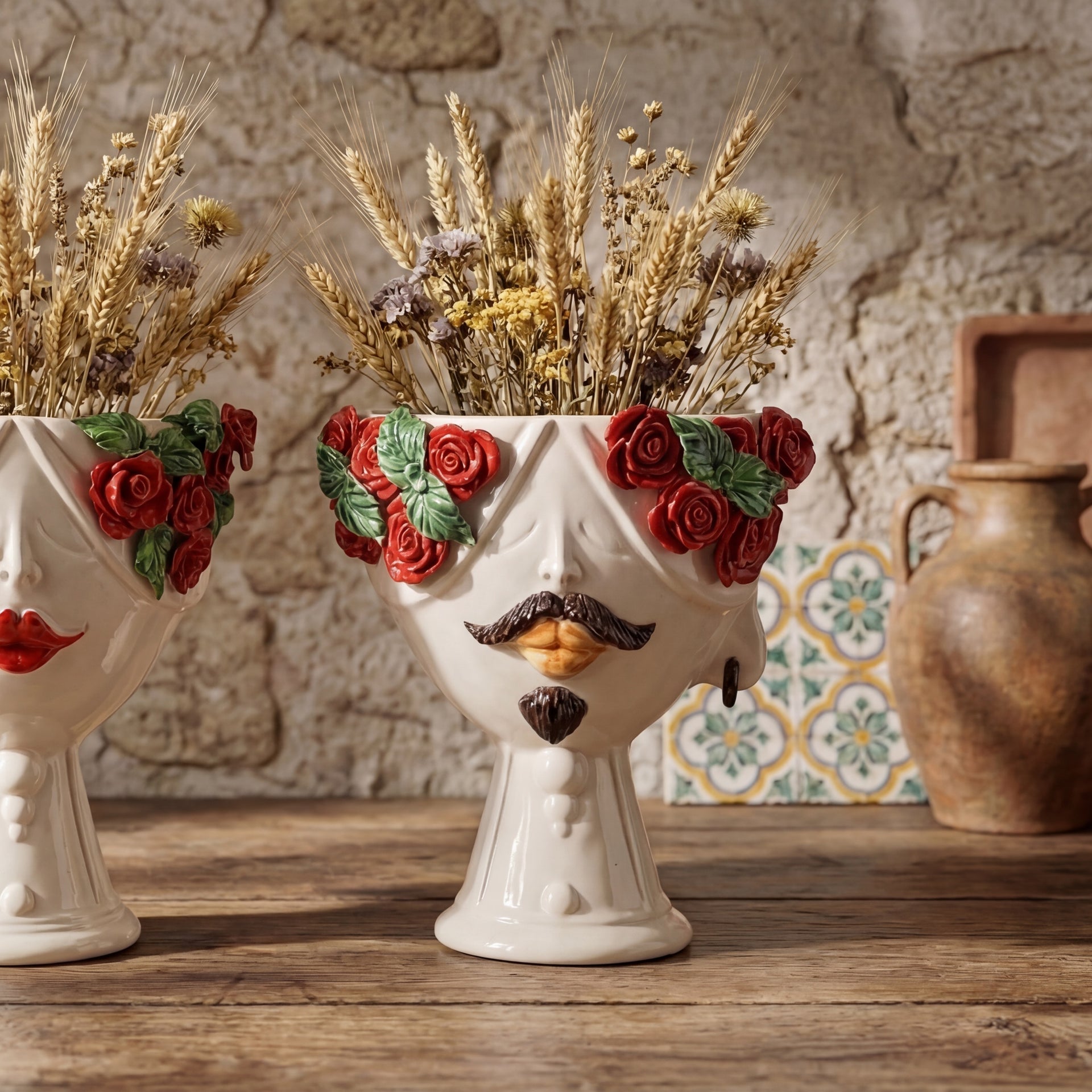 Handmade Teste di Moro vase with red roses, mustache, and dried wheat, blending tradition and modern design.