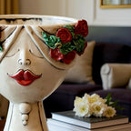 Handmade Teste di Moro ceramic vase with red roses and bold lips, blending Sicilian tradition with modern decor