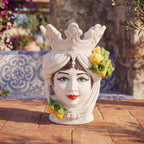 Handcrafted Teste di Moro ceramic vase with crown, lemons, and blue tile background, blending tradition and modern design.