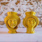 Handmade yellow Teste di Moro ceramic vases with male and female faces, traditional Sicilian decor