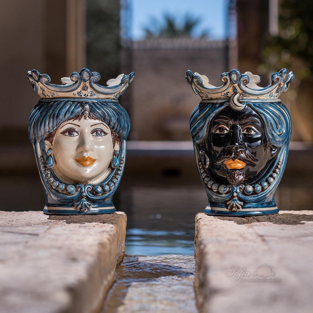 Handmade Teste di Moro ceramic vases with crowned faces, blue and white glaze, outdoor fountain setting