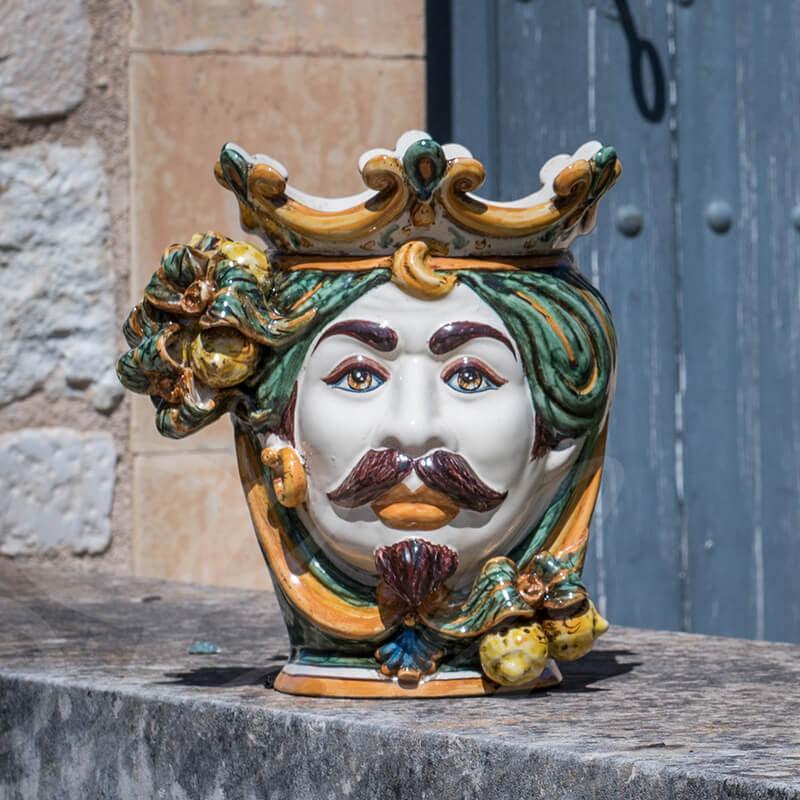 Handcrafted Teste di Moro ceramic face with crown, vibrant colors, traditional Sicilian design