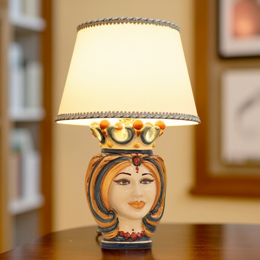 Handmade Teste di Moro table lamp with ceramic queen head, crown, and warm light shade