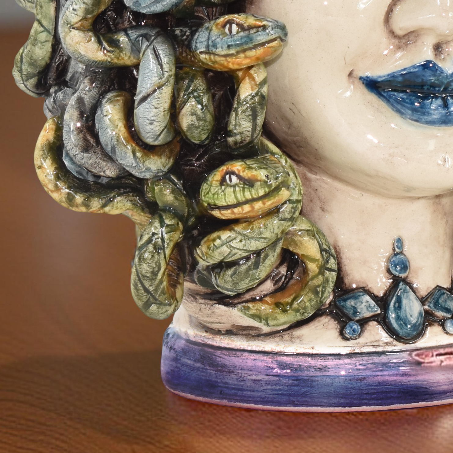 Handcrafted Teste di Moro ceramic with detailed snakes and blue lips, blending tradition and modern design.
