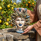 Handcrafted Teste di Moro ceramic with snake hair, blue lips, and citrus garden backdrop