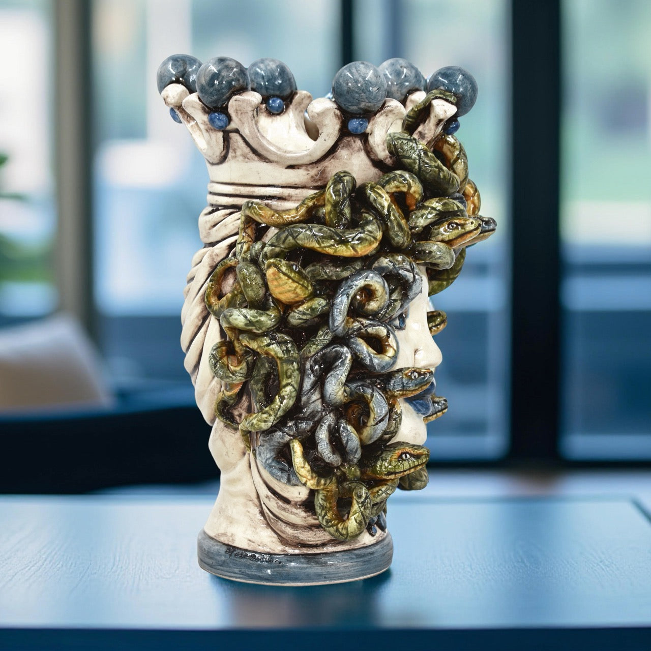 Handcrafted Medusa head sculpture with serpentine hair and crown, blending tradition and modern design.