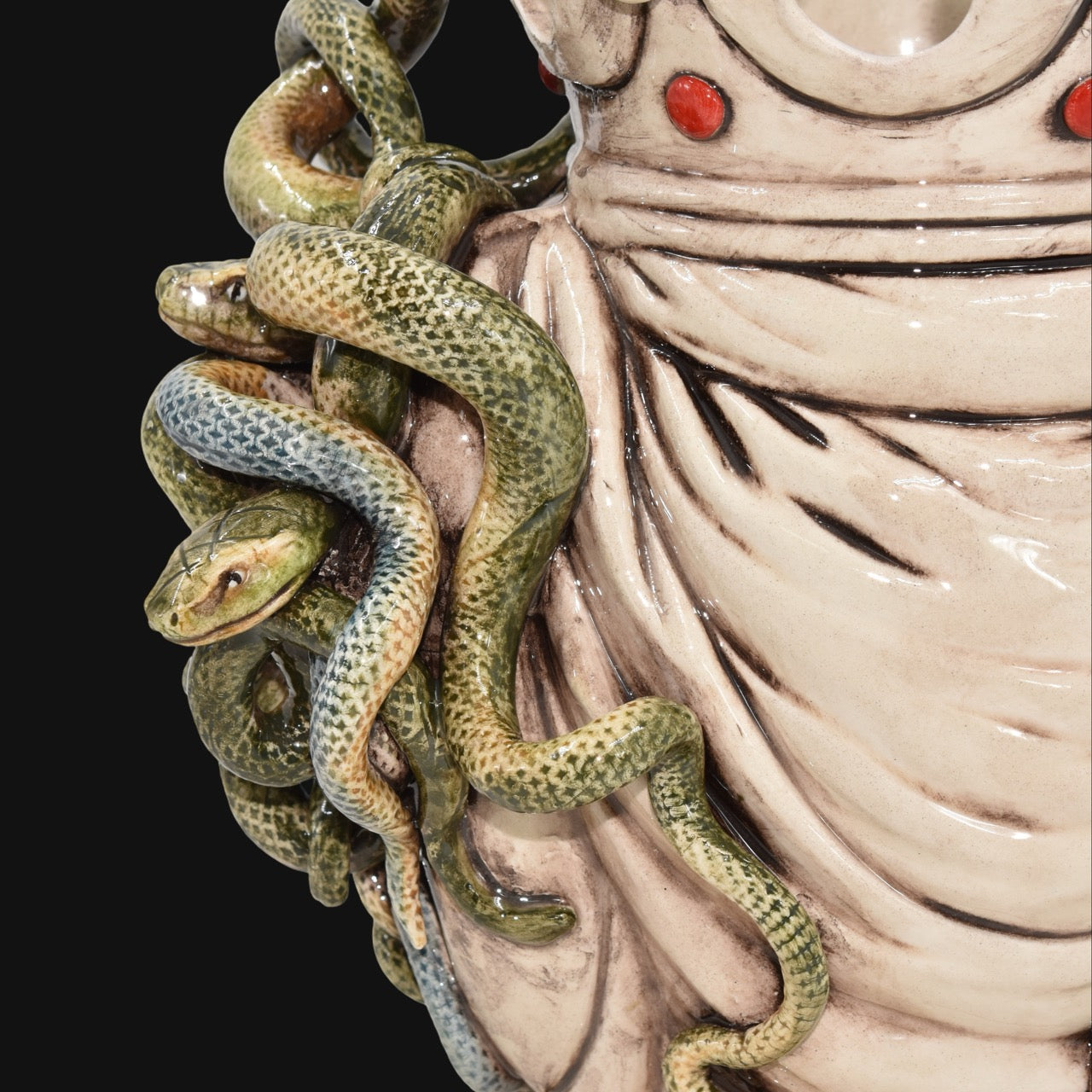 Handcrafted Teste di Moro ceramic with coiled green snakes and red accents, blending tradition and modern design.