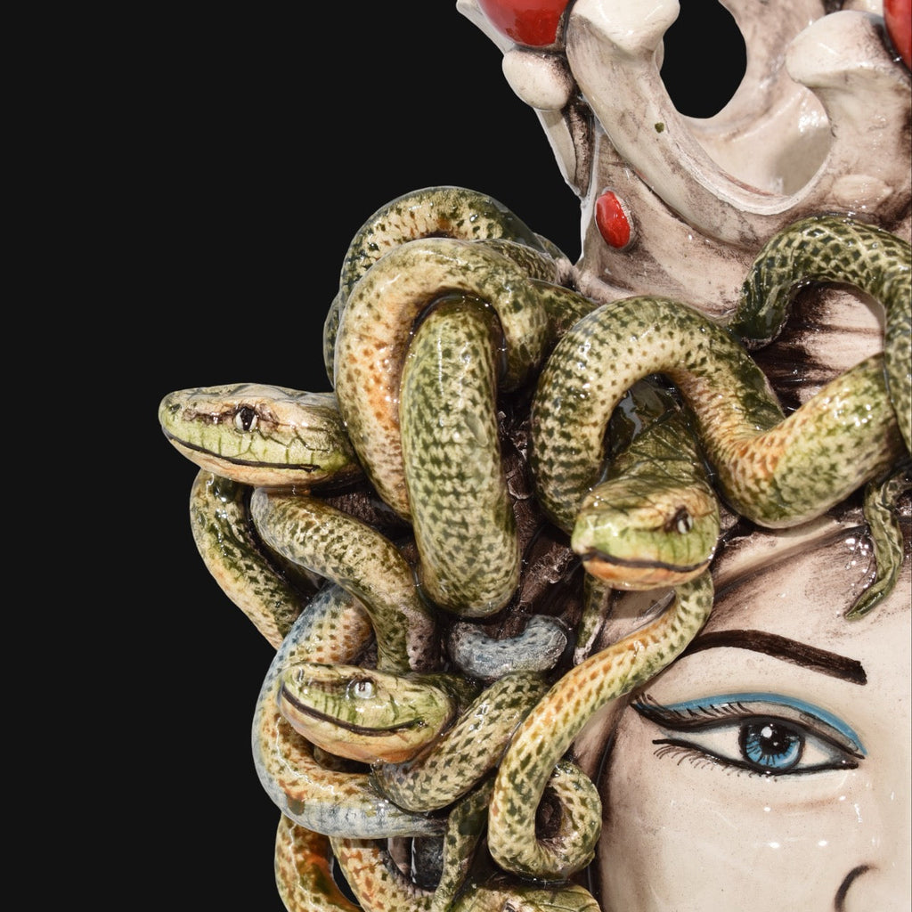 Handcrafted Teste di Moro with intricate green snakes and vibrant blue eyes, blending tradition and modern design.